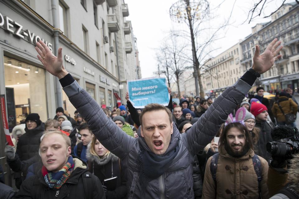 FILE - In this Sunday, Jan. 28, 2018 file photo, Russian opposition leader Alexei Navalny, center, attends a rally in Moscow, Russia. The German government says specialist labs in France and Sweden have confirmed Russian opposition leader Alexei Navalny was poisoned with the Soviet-era nerve agent Novichok. (AP Photo/Evgeny Feldman, File)