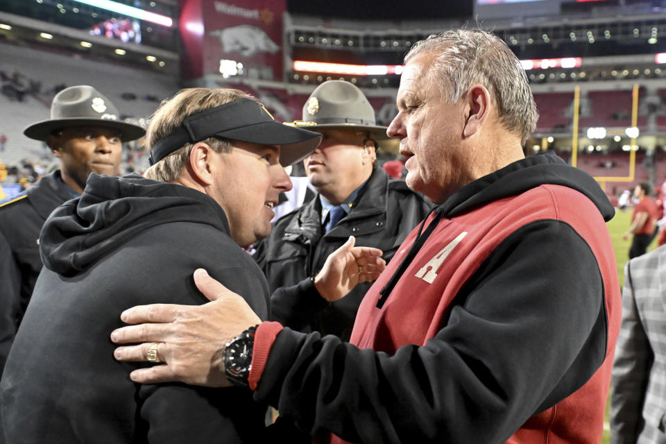 Missouri coach Eliah Drinkwitz, left, and Arkansas coach Sam Pittman shake hands after an NCAA college football game Friday, Nov. 24, 2023, in Fayetteville, Ark. (AP Photo/Michael Woods)