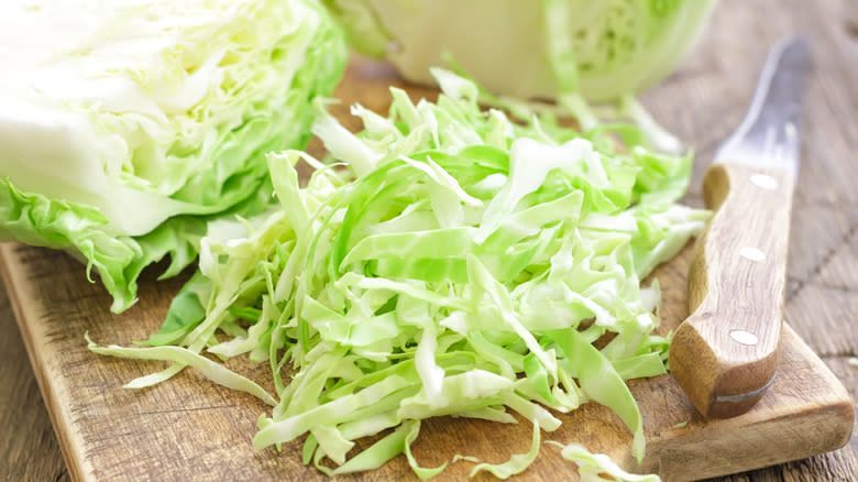 Shredded cabbage on wooden board