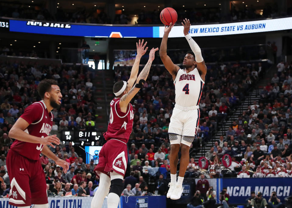 <p>Malik Dunbar #4 of the Auburn Tigers shoots the ball during the second half against the New Mexico State Aggies in the first round of the 2019 NCAA Men’s Basketball Tournament at Vivint Smart Home Arena on March 21, 2019 in Salt Lake City, Utah. (Photo by Tom Pennington/Getty Images) </p>