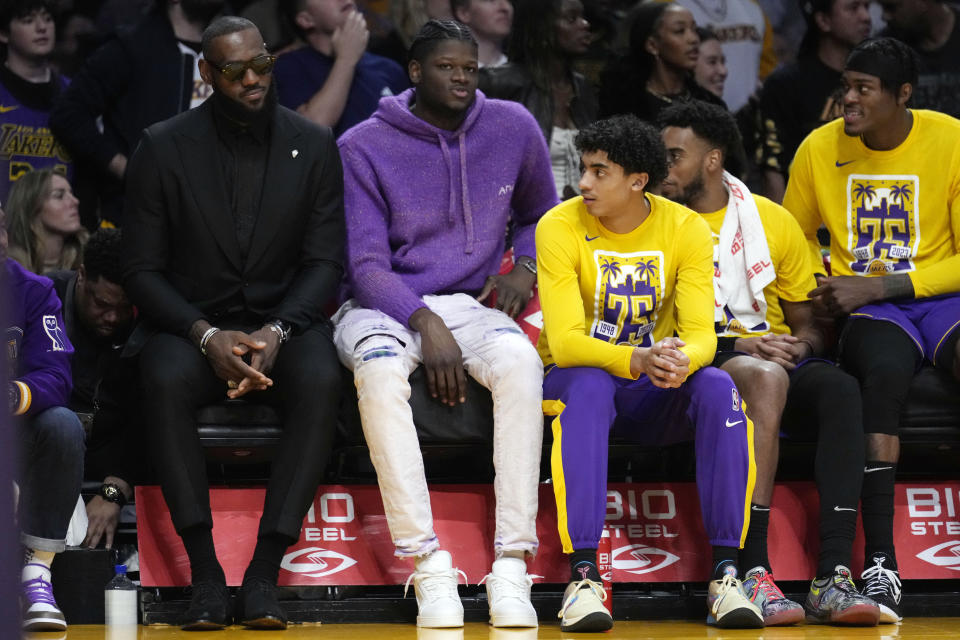Los Angeles Lakers forward LeBron James, left, and center Mo Bamba watch from the bench during the second half of an NBA basketball game against the Dallas Mavericks Friday, March 17, 2023, in Los Angeles. (AP Photo/Marcio Jose Sanchez)