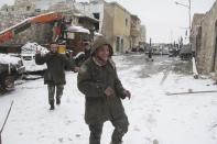 Free Syrian army fighters play with snow in Aleppo's Karm al-Jabal district, December 13,2013. Picture taken December 13,2013. REUTERS/Saad AboBrahim (SYRIA - Tags: POLITICS CIVIL UNREST CONFLICT)