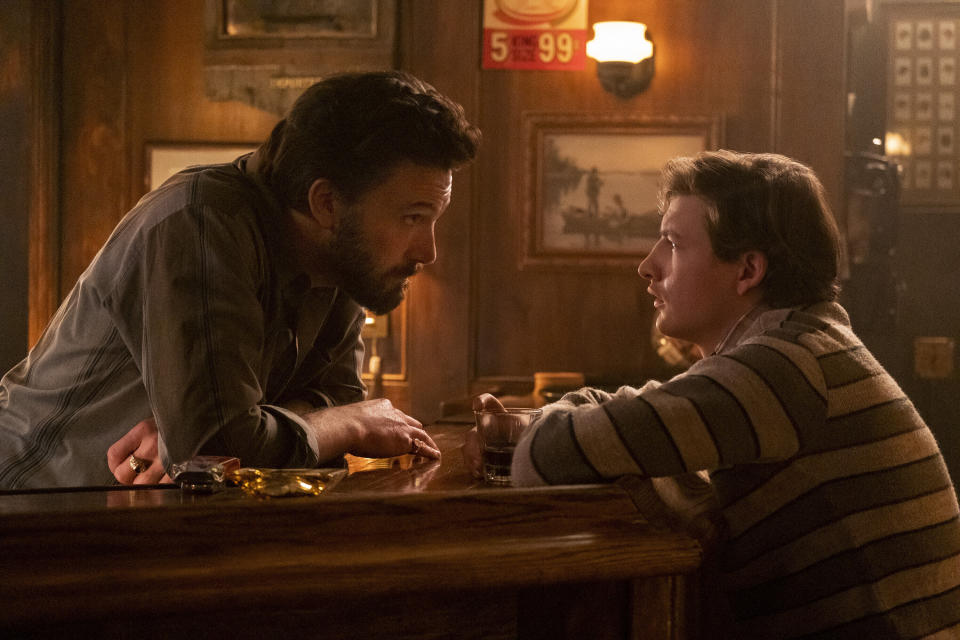 This image released by Amazon shows Ben Affleck, left, and Tye Sheridan in a scene from "The Tender Bar." (Claire Folger/Amazon via AP)