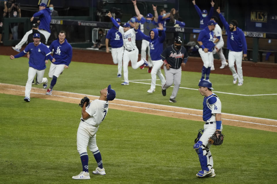 Los Angeles Dodgers starting pitcher Julio Urias celebrates their win against the Atlanta Braves in Game 7 of a baseball National League Championship Series Sunday, Oct. 18, 2020, in Arlington, Texas. (AP Photo/Tony Gutierrez)