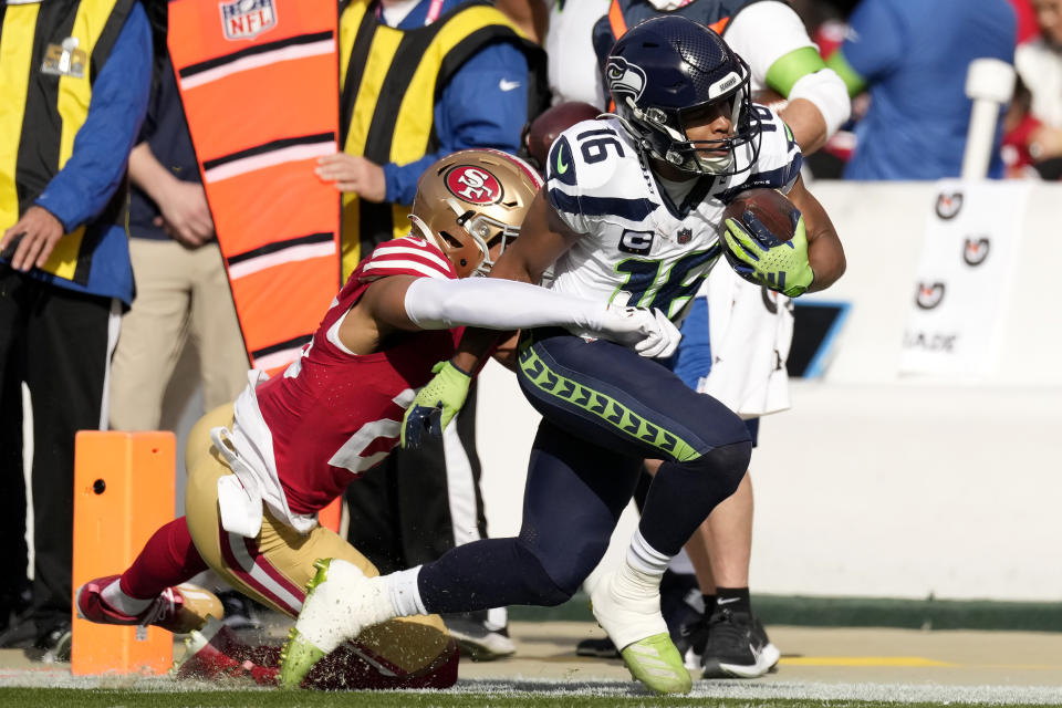 Seattle Seahawks wide receiver Tyler Lockett (16) is tackled by San Francisco 49ers cornerback Isaiah Oliver during the first half of an NFL football game in Santa Clara, Calif., Sunday, Dec. 10, 2023. (AP Photo/Godofredo A. Vásquez)