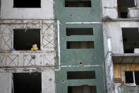 A teddy bear is seen on a building destroyed by attacks in Chernihiv, Ukraine, Sunday, June 19, 2022. (AP Photo/Natacha Pisarenko)