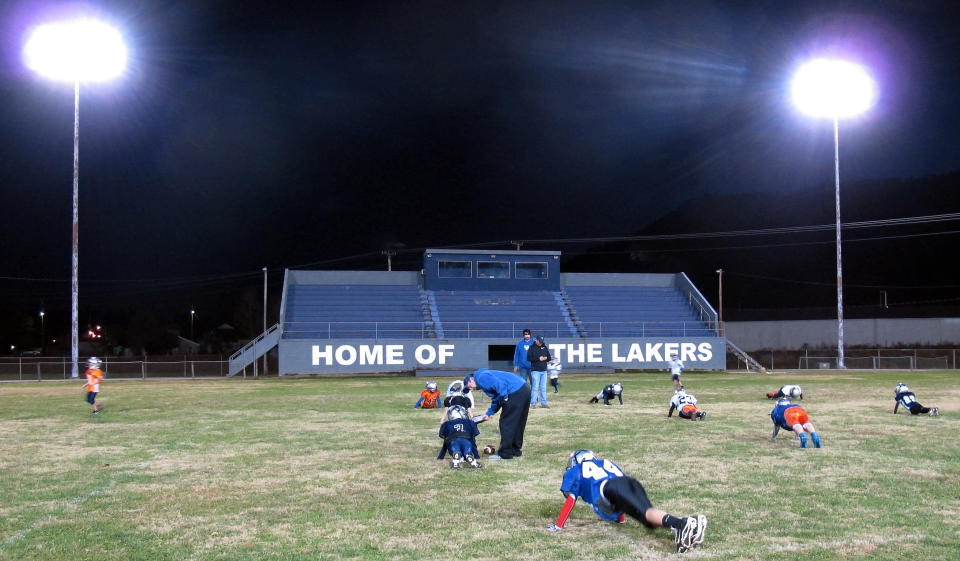 In this Thursday, Nov. 7, 2013 photo, a football practice is held at a community field in Lake City, Tenn. The town is considering changing its name to Rocky Top to cash in on the famous bluegrass song. The city took the first step Thursday, when the city council voted in favor of the change. (AP Photo/Travis Loller)