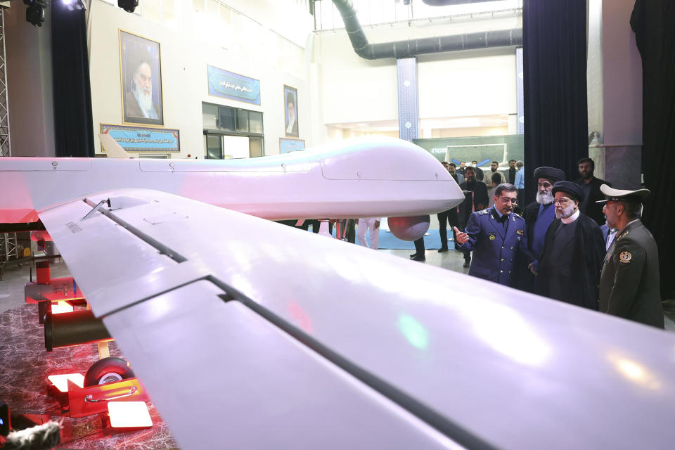 In this photo released by the Iranian Presidency Office, President Ebrahim Raisi, second right, listens to Chief of Aviation Industries of Armed Forces Gen. Afshin Khajehfard as Defense Minister Gen. Mohammad Reza Gharaei Ashtiani, right, listens, during a ceremony unveiling a drone called the Mohajer-10, Tuesday, Aug. 22, 2023. Iran's Defense Ministry unveiled a drone Tuesday resembling America's armed MQ-9 Reaper, claiming that the aircraft capable of staying airborne for 24 hours and having the range to reach its archenemy Israel. (Iranian Presidency Office, via AP)