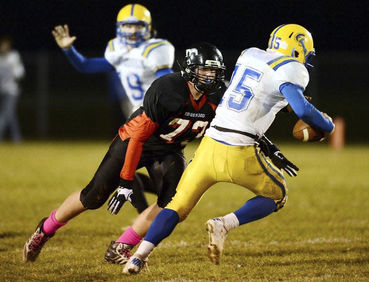 Edgewood's Brayden Patton (73) pressures Crawfordsville's Travis Harris (15) during the Edgewood Crawfrodsville sectional football game at Edgewood High School in Ellettsville , Ind., Friday, Oct. 25, 2013. Chris Howell | Herald-Times