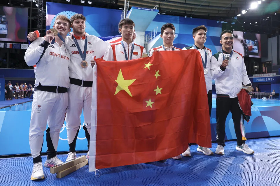 PARIS, FRANCE - AUGUST 02: Gold Medalists Long Daoyi and Wang Zongyuan of Team People's Republic of China (C), Silver Medalists Juan Manuel Celaya Hernandez and Osmar Olvera Ibarra of Team Mexico (R) and Bronze Medalists Anthony Harding and Jack Laugher of Team Great Britain (L) pose following the Diving medal ceremony after the Men's Synchronised 3m Springboard Final on day seven of the Olympic Games Paris 2024 at Aquatics Centre on August 02, 2024 in Paris, France. (Photo by Quinn Rooney/Getty Images)