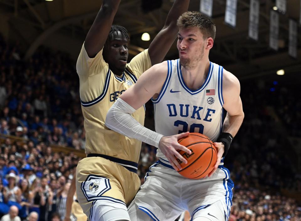 Jan 13, 2024; Durham, North Carolina, USA; Duke Blue Devils center Kyle Filipowski (30) drives to the basket as Georgia Tech Yellow Jackets forward Baye Ndongo (11) defends during the second half at Cameron Indoor Stadium. The Blue Devils won 84-79. Mandatory Credit: Rob Kinnan-USA TODAY Sports