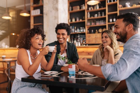 Two men and two women meeting in a coffee shop