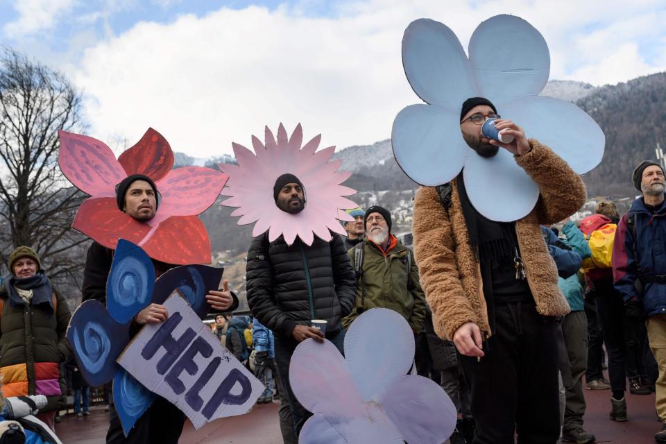 Flower power: climate activists prepare to march in Davos, Switzerland: AFP/Getty