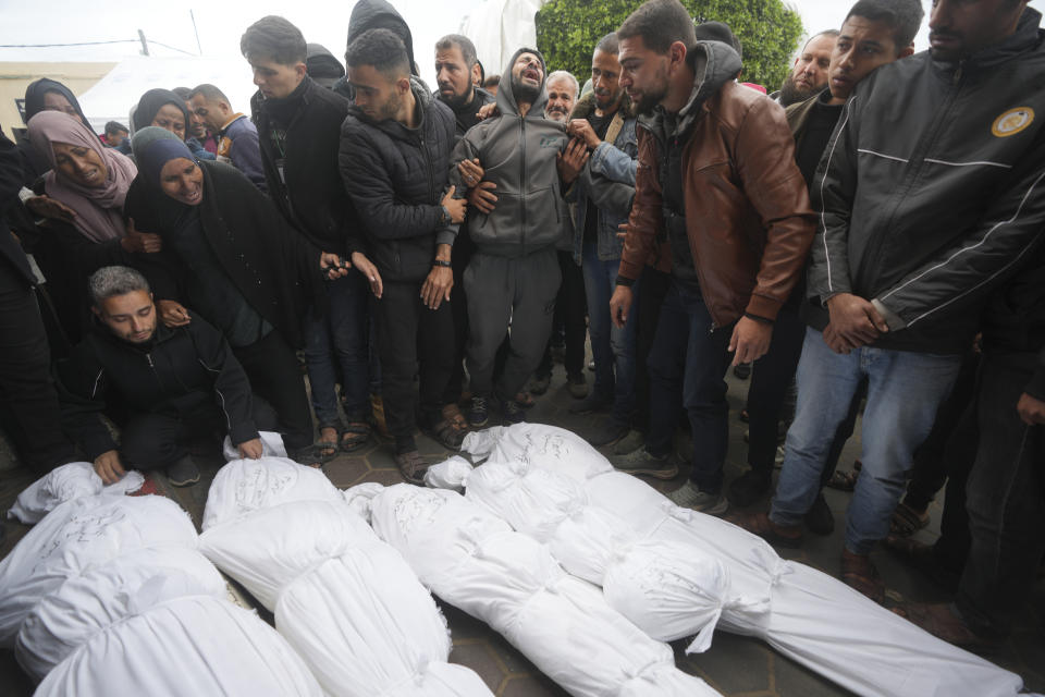 Palestinians mourn relatives killed in the Israeli bombardments of the Gaza Strip in front of the morgue of the Al Aqsa Hospital in Deir al Balah, Gaza Strip, on Thursday, March 7, 2024. (AP Photo/Adel Hana)
