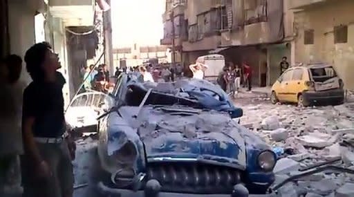 An image grab taken from a video uploaded on YouTube on August 7 shows Syrians inspecting damages in the Bustan al-Qasr district of the northern city of Aleppo. President Bashar al-Assad vowed on Tuesday to crush the 17-month rebellion against his regime and to cleanse Syria of "terrorists," as his troops engaged rebels in Aleppo