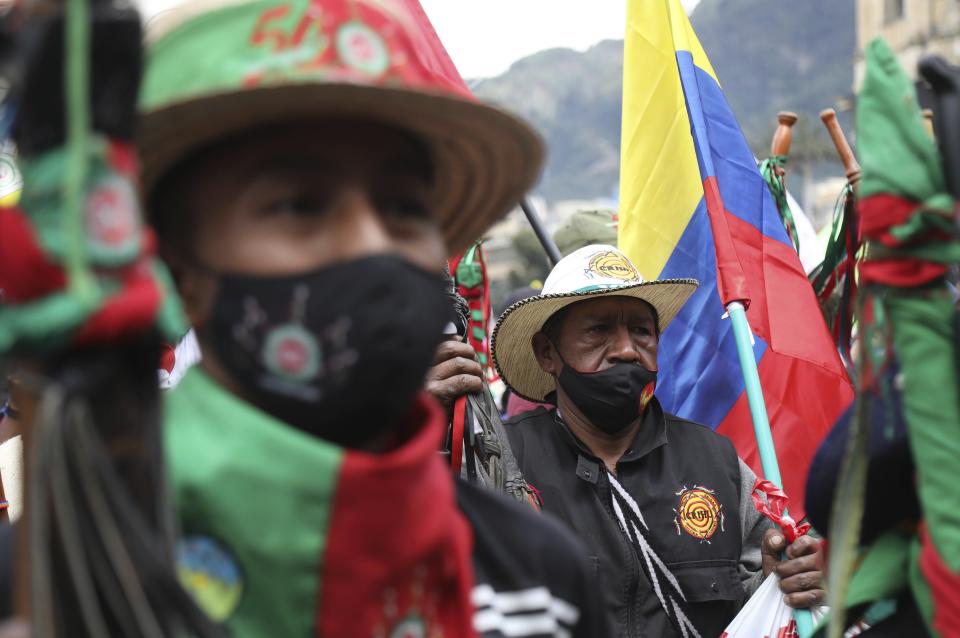 Members of the Indigenous Guard march against the government’s handling of a wide range of issues including the economic fallout of the pandemic and implementation of the peace accord, in Bogota, Colombia, Wednesday, Oct. 21, 2020. Indigenous leaders, students and union members gathered in Plaza Bolivar waving flags and banners decrying the government nearly one year after massive protests rocked the country only to fizzle with little to show by way of reform. (AP Photo/Fernando Vergara)