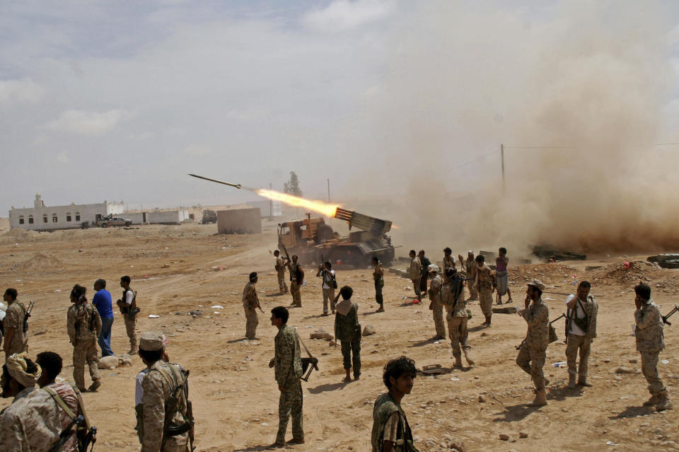 FILE - Yemeni army soldiers fire rockets at mountainous positions of al-Qaida militants at the town of Meyfaa in the southern province of Shabwa, Yemen in May 2014 file photo provided by Yemen's Defense Ministry. Al-Qaida took over multiple towns in Shabwa in 2015 and held them until they withdrew in late 2017 and early 2018. The AP found that they pulled out under secret deals with the U.S.-backed coalition that allowed them to take weapons and cash with them, integrated some of its fighters into coalition-backed forces and even paid off some militants. (AP Photo/Yemen's Defense Ministry, File)