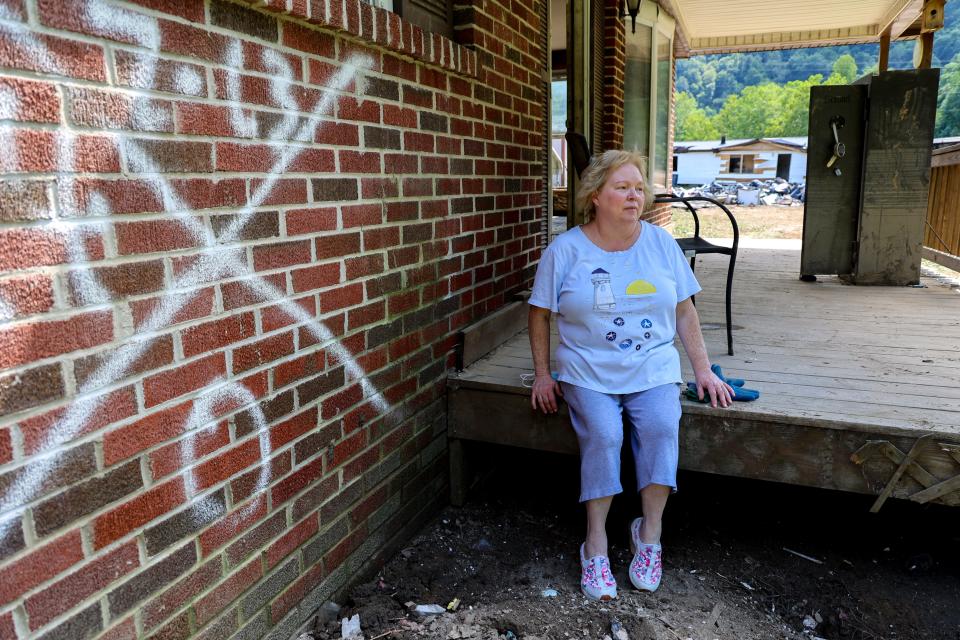 In Pilgrim’s Knob, Va., Sherry Honaker, 55, oversees the removal of debris from her niece's home on Dismal Creek. It was gutted in a major flood, the county’s second this year.