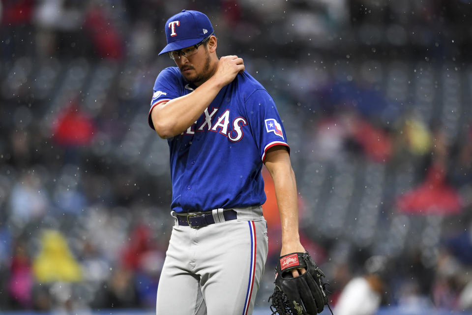 Texas Rangers' Dane Dunning walks off the field after working the third inning of the team's baseball game against the Cleveland Guardians, Wednesday, June 8, 2022, in Cleveland. (AP Photo/Nick Cammett)