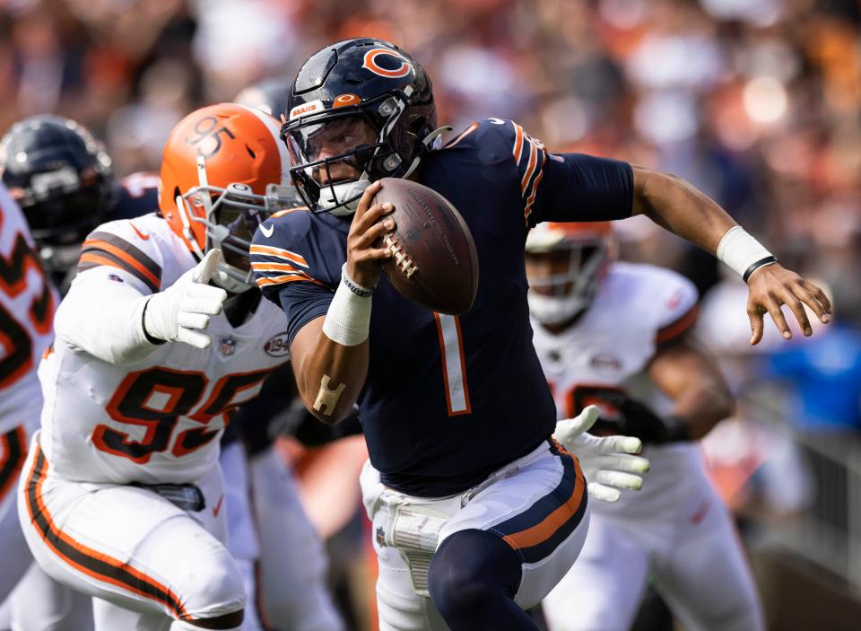 Browns defensive end Myles Garrett reaches for Bears QB Justin Fields in the third quarter. Fields was sacked nine times Sunday.