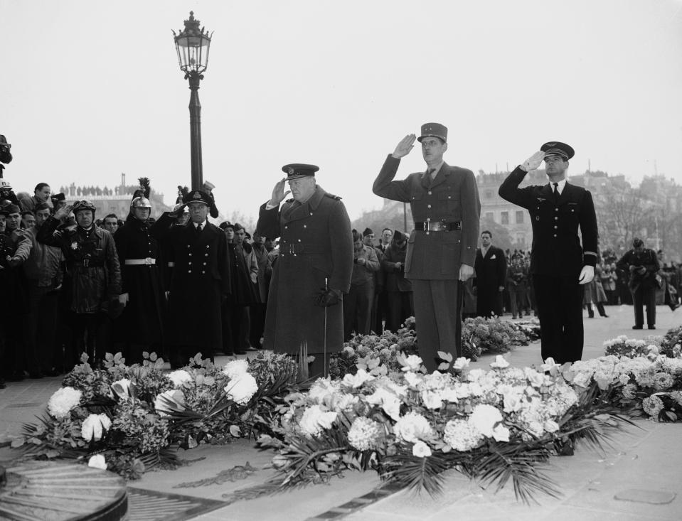 FILE - In this Nov. 12, 1944 file photo, Britain's Prime Minister Winston Churchill, left, and General Charles De Gaulle, centre, salute at France's Unknown Warrior at the Arc De Triomphe in Paris. Though allies in World War II, De Gaulle twice vetoed Britain's application in the 1960s to join what was then known as the European Economic Community. Britain eventually joined in 1973 after De Gaulle's successor, Georges Pompidou, lifted France's veto. On Jan. 31, 2020, Britain is scheduled to leave what became known as the European Union. (AP Photo, File)