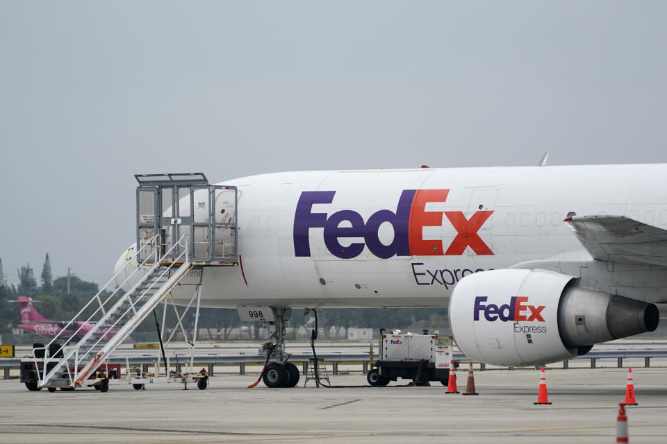 A FedEx cargo plane is shown on the tarmac at Fort Lauderdale-Hollywood International Airport, Tuesday, April 20, 2021, in Fort Lauderdale, Fla. FedEx is getting hurt by the tight job market. The package delivery company said Tuesday, Sept. 21 that its costs are up $450 million in the most recent quarter, as it paid higher wages as it got harder to find new workers and demand for shipping increased. (AP Photo/Wilfredo Lee)