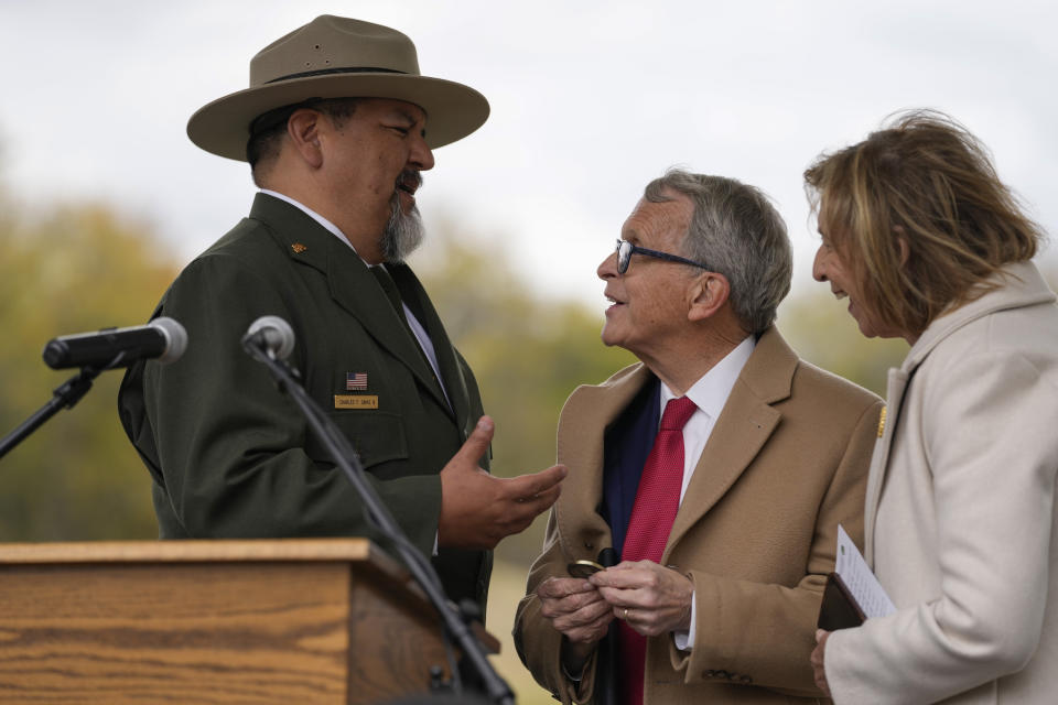 Ohio Gov. Mike DeWine and his spouse, Frances, and National Park Service Director Chuck Sams, talk after the Hopewell Ceremonial Earthworks UNESCO World Heritage Inscription Commemoration ceremony at the Mound City Group at Hopewell Culture National Historical Park in Chillicothe, Ohio, Saturday, Oct. 14, 2023. A network of ancient American Indian ceremonial and burial mounds in Ohio noted for their good condition, distinct style and cultural significance, including Hopewell, was added to the list of UNESCO World Heritage sites. (AP Photo/Carolyn Kaster)