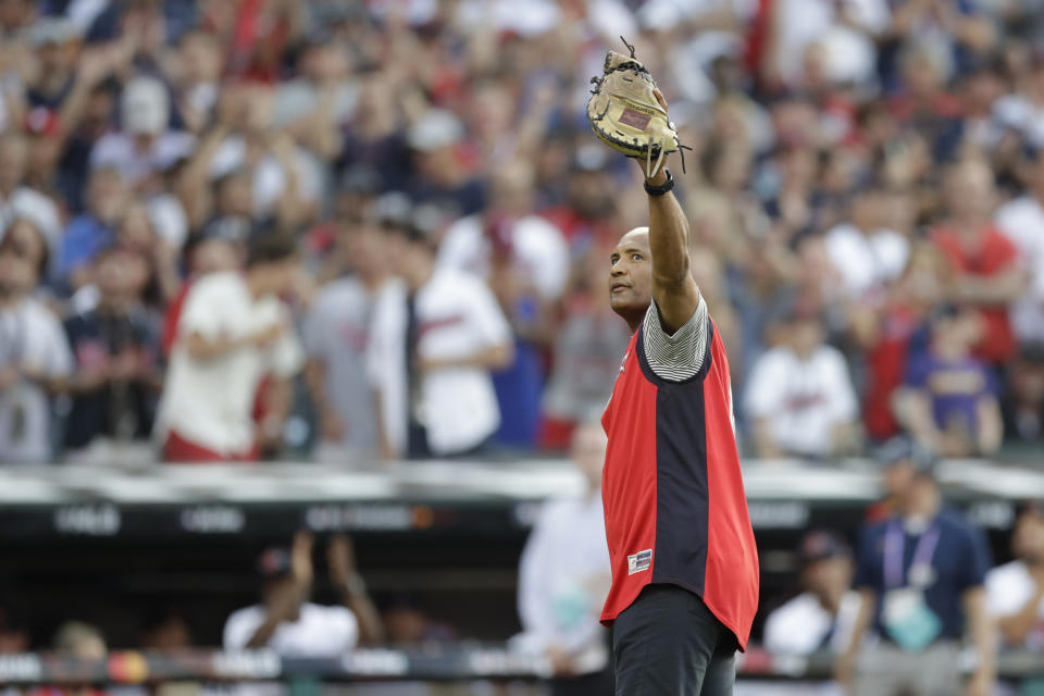 Baseball great Sandy Alomar acknowledges the fans after catching a ceremonial first pitch before the start of the MLB baseball All-Star Game, Tuesday, July 9, 2019, in Cleveland. (AP Photo/Tony Dejak)