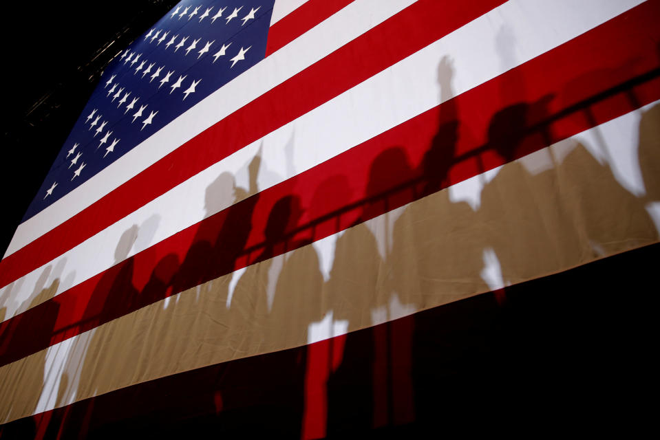 The shadows of supporters of U.S. President Donald Trump are seen on an American Flag at a campaign rally in Las Vegas, Nevada, U.S., September 20, 2018. REUTERS/Mike Segar