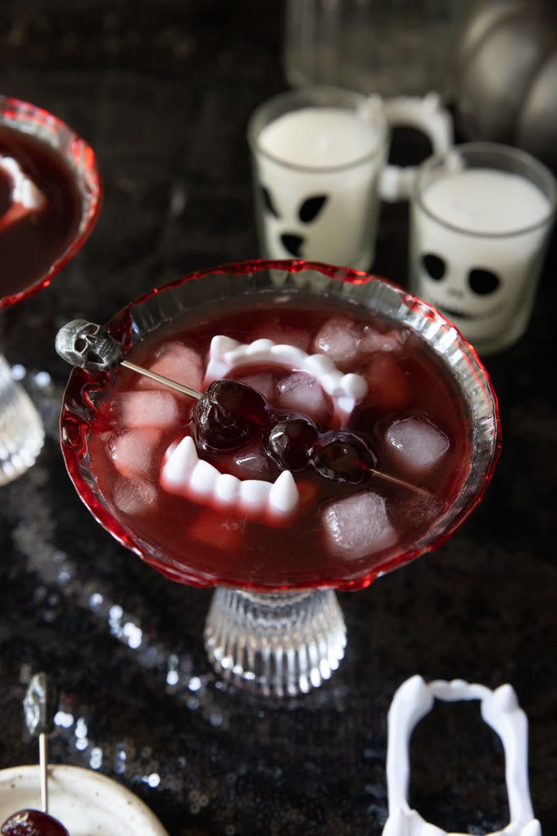 a glass bowl with red liquid and berries in it