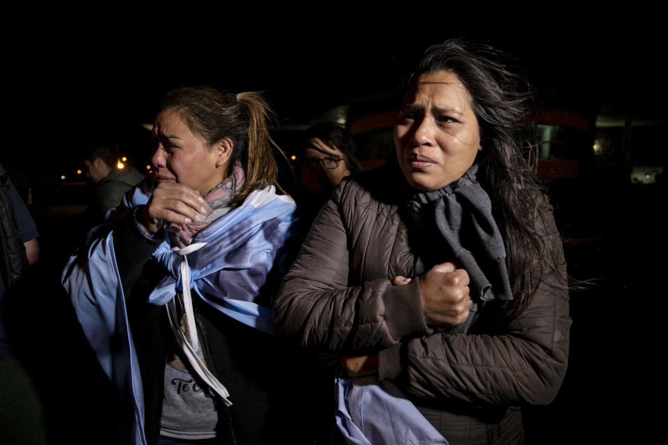 Relatives of the crew of the ARA San Juan submarine embrace outside the navy base in Mar del Plata, Argentina, Saturday, Nov. 17, 2018. Argentina's navy announced early Saturday, that they have located the missing submarine ARA San Juan in the Atlantic a year after it disappeared with 44 crew members aboard.(AP Photo/Federico Cosso)