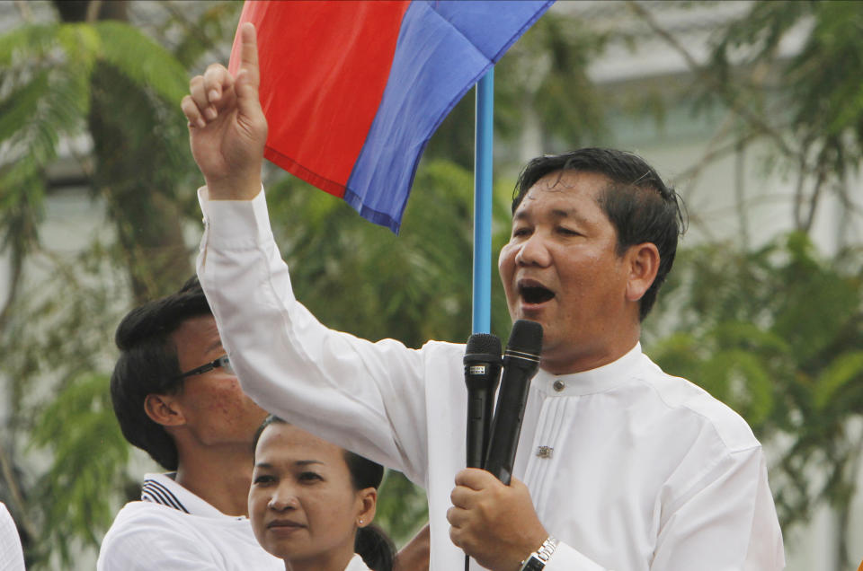 FILE - Thach Setha, a prominent vice president of the country's main opposition, Candlelight Party, talks to media members near the Vietnam Embassy in Phnom Penh, Cambodia, on Aug. 10, 2014. A top Cambodian opposition politician who was sentenced last month to 18 months in prison for issuing worthless checks has been convicted and sentenced to three years additional imprisonment for incitement to commit a felony and incitement to discriminate on the basis of race, religion or nationality. (AP Photo/Heng Sinith, File)