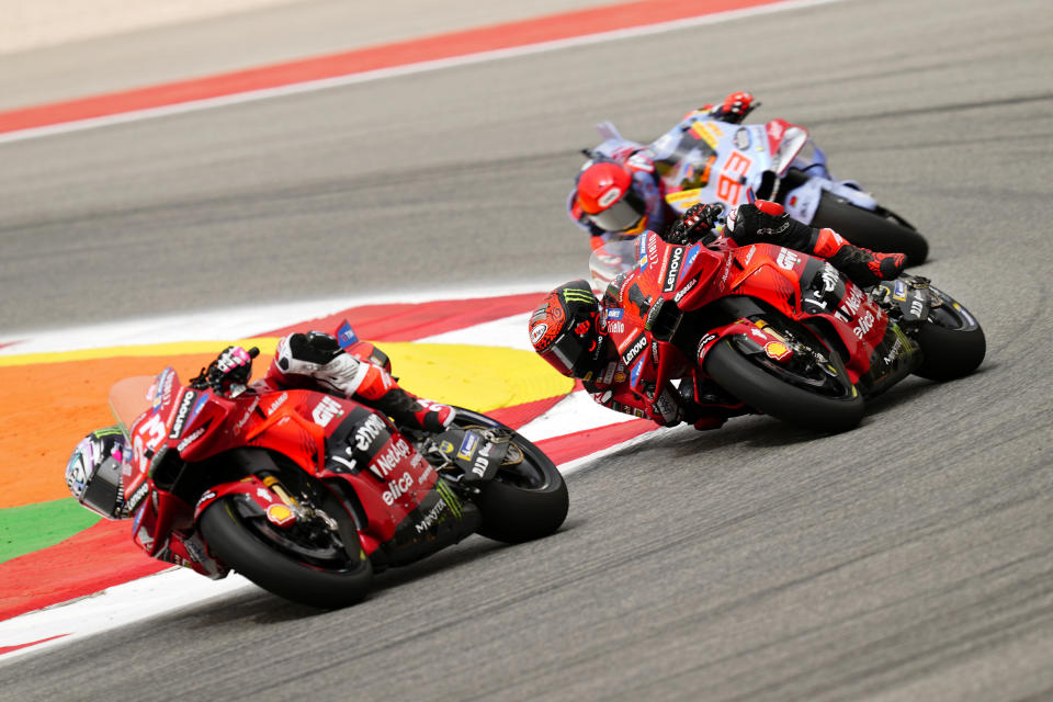 MotoGP rider Enea Bastianini of Italy, left, takes a curve followed by Francesco Bagnaia, also of Italy, and Marc Marquez of Spain during the Portuguese Motorcycle Grand Prix at the Algarve International circuit near Portimao, Portugal, Sunday, March 24, 2024. (AP Photo/Jose Breton)