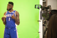 Philadelphia 76ers' Norvel Pelle reacts to eating a donut for a Sixers.com gif during media day at the NBA basketball team's practice facility, Friday, Sept. 21, 2018, in Camden. (AP Photo/Chris Szagola)