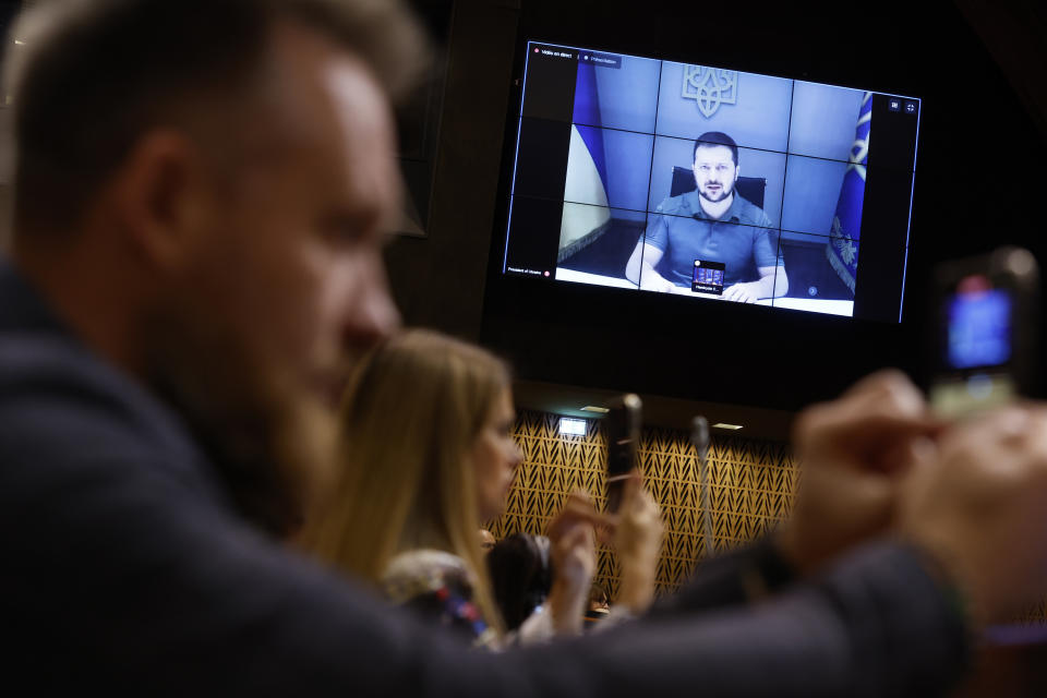 Ukrainian President Volodymyr Zelenskyy speaks during a video address to the European Council, Thursday, Oct. 13, 2022 in Strasbourg, eastern France. Ukraine's capital region was struck by Iranian-made kamikaze drones early Thursday, officials said, sending rescue workers rushing to the scene as residents awoke to air raid sirens for the fourth consecutive morning following Russia's major assault across the country earlier this week. (AP Photo/Jean-Francois Badias)