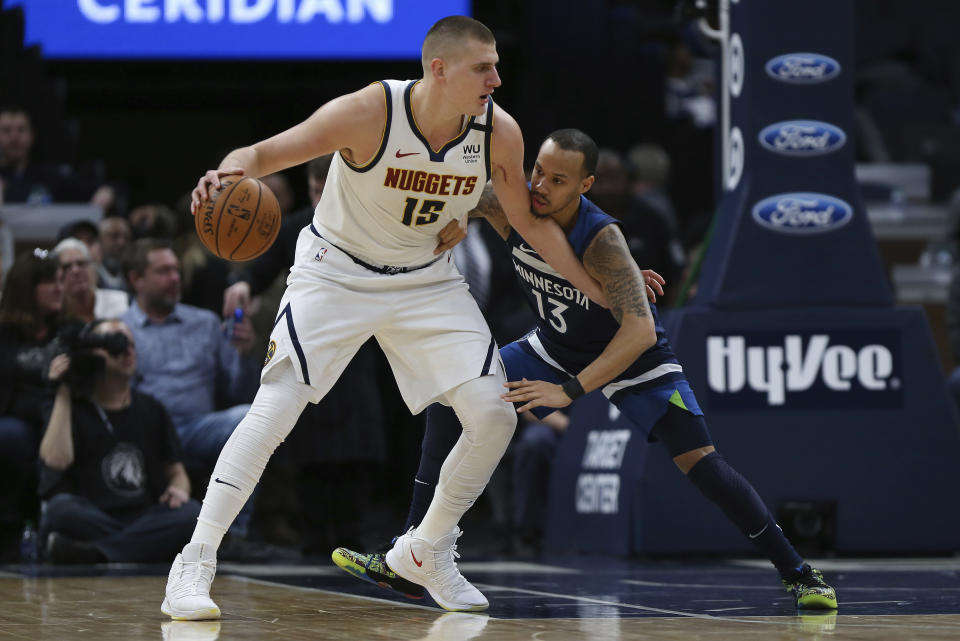Denver Nuggets' Nikola Jokic controls the ball against Minnesota Timberwolves' Shabazz Napier in the first half of an NBA basketball game Monday, Jan. 20, 2020, in Minneapolis. (AP Photo/Stacy Bengs)