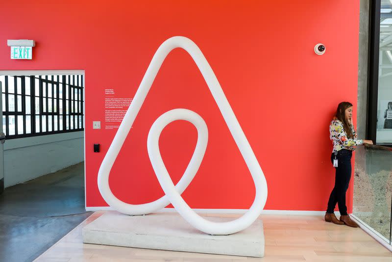 A woman talks on the phone at the Airbnb office headquarters in the SOMA district of San Francisco