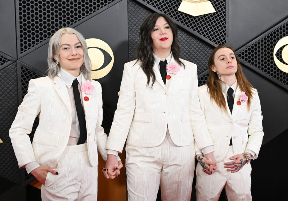 Phoebe Bridgers, Lucy Dacus and Julien Baker of Boygenius wear Artists4Ceasefire pins at the 2024 Grammy Awards.