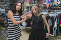 <p>Yahoo Global News Anchor Katie Couric flexes her muscles with the assistance of actress Gal Gadot at the Midtown Comics in New York City. (Gordon Donovan/Yahoo News) </p>