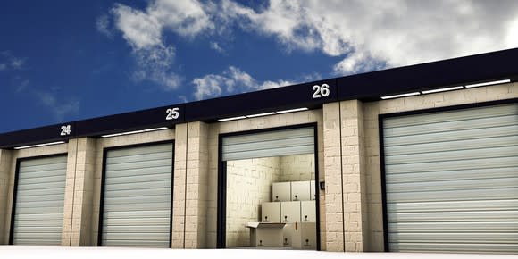 A row of self-storage units, with boxes visible inside one open unit.