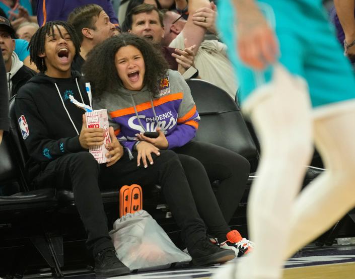 Phoenix Suns fan Breanna Amado celebrates a basket against the Charlotte Hornets during the fourth quarter at Footprint Center in Phoenix on Jan. 24, 2023. Make-A-Wish and the Suns hosted her and her family at the game.