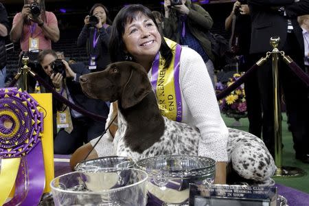 Handler Valerie Nunez Atkinson poses with CJ, a German Shorthaired Pointer from the Sporting Group, after they won Best in Show at the Westminster Kennel Club Dog show at Madison Square Garden in New York February 16, 2016. REUTERS/Brendan McDermid