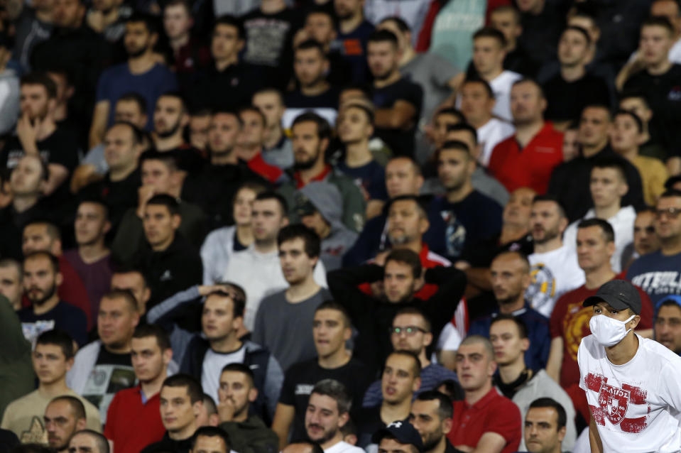 Red Star fans watch the Serbian National Cup semi final soccer match between Partizan and Red Star in Belgrade, Serbia, Wednesday, June 10, 2020. (AP Photo/Darko Vojinovic)