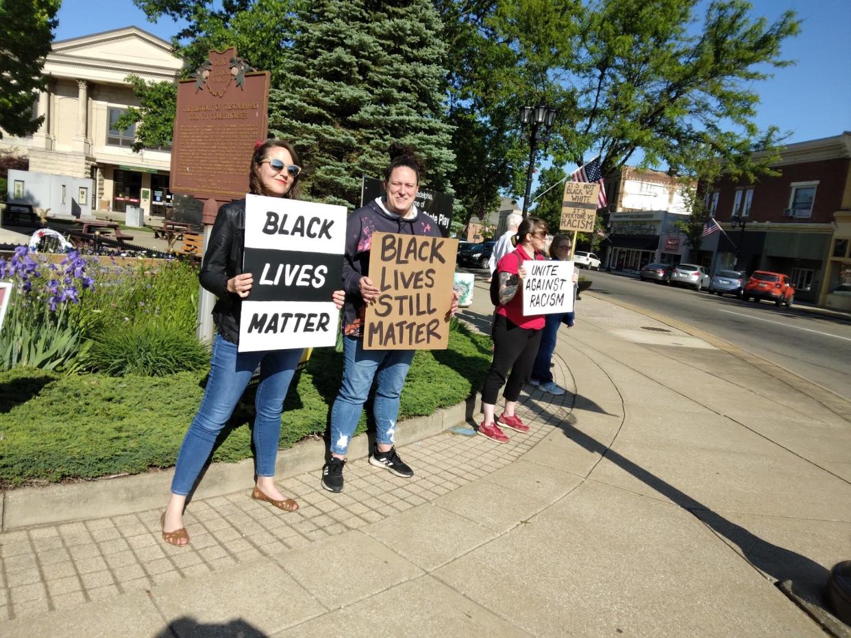 Standing Thursday on the square in New Philadelphia on the third anniversary of George Floyd's murder are Hannah Hartman, Alicia Hall, Mallory Gerstacker and Kari Sommers, left to right.