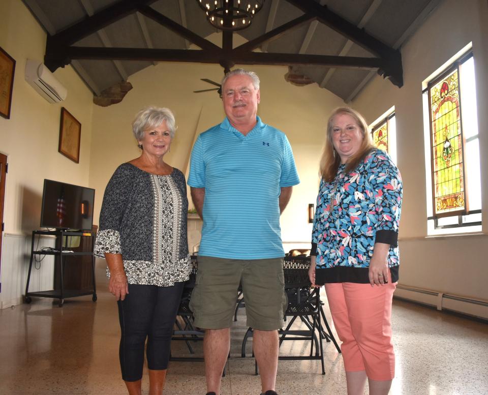 From left: Mary and Mark Murray, owners of the Adrian Armory Events Center since 2016, and Sheila Blair, right, team leader of Launch Lenawee, stand in the Bravo Room at the Armory on Tuesday, July 2, 2024.