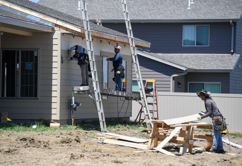 Construction workers install siding on a new home on Thursday, July 14, 2022, on Ronsiek Avenue in Sioux Falls.