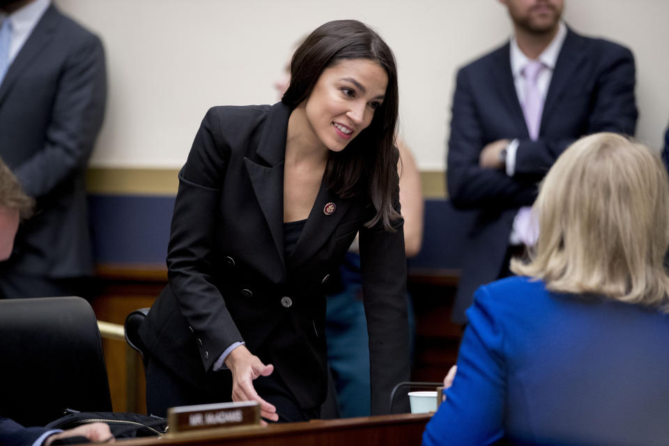 Rep. Alexandria Ocasio-Cortez, D-N.Y., appears before Facebook CEO Mark Zuckerberg arrives for a House Financial Services Committee hearing on Capitol Hill in Washington, Wednesday, Oct. 23, 2019, on Facebook's impact on the financial services and housing sectors. (AP Photo/Andrew Harnik)