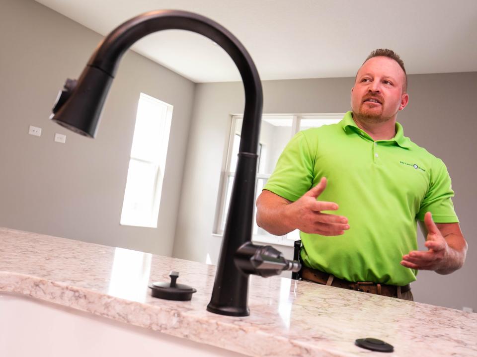 Utility Director Bryan Schmalz with Bay Laurel Center CDD talks about how his company is implementing requirements for new construction homes to help conserve water while touring a home at Weybourne Landing in On Top of the World on May 31.