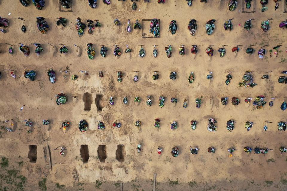 An aerial view of crosses, floral tributes and photographs of the victims of the battles for Irpin and Bucha that mark the graves in Irpin cemetery on May 16, 2022 in Irpin, Ukraine. (Christopher Furlong/Getty Images)