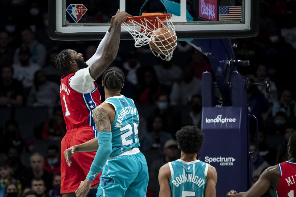 Philadelphia 76ers center Andre Drummond (1) makes a slam dunk over Charlotte Hornets forward P.J. Washington (25) and guard James Bouknight (5)during the first half of an NBA basketball game, Wednesday, Dec. 8, 2021, in Charlotte, N.C. (AP Photo/Matt Kelley)